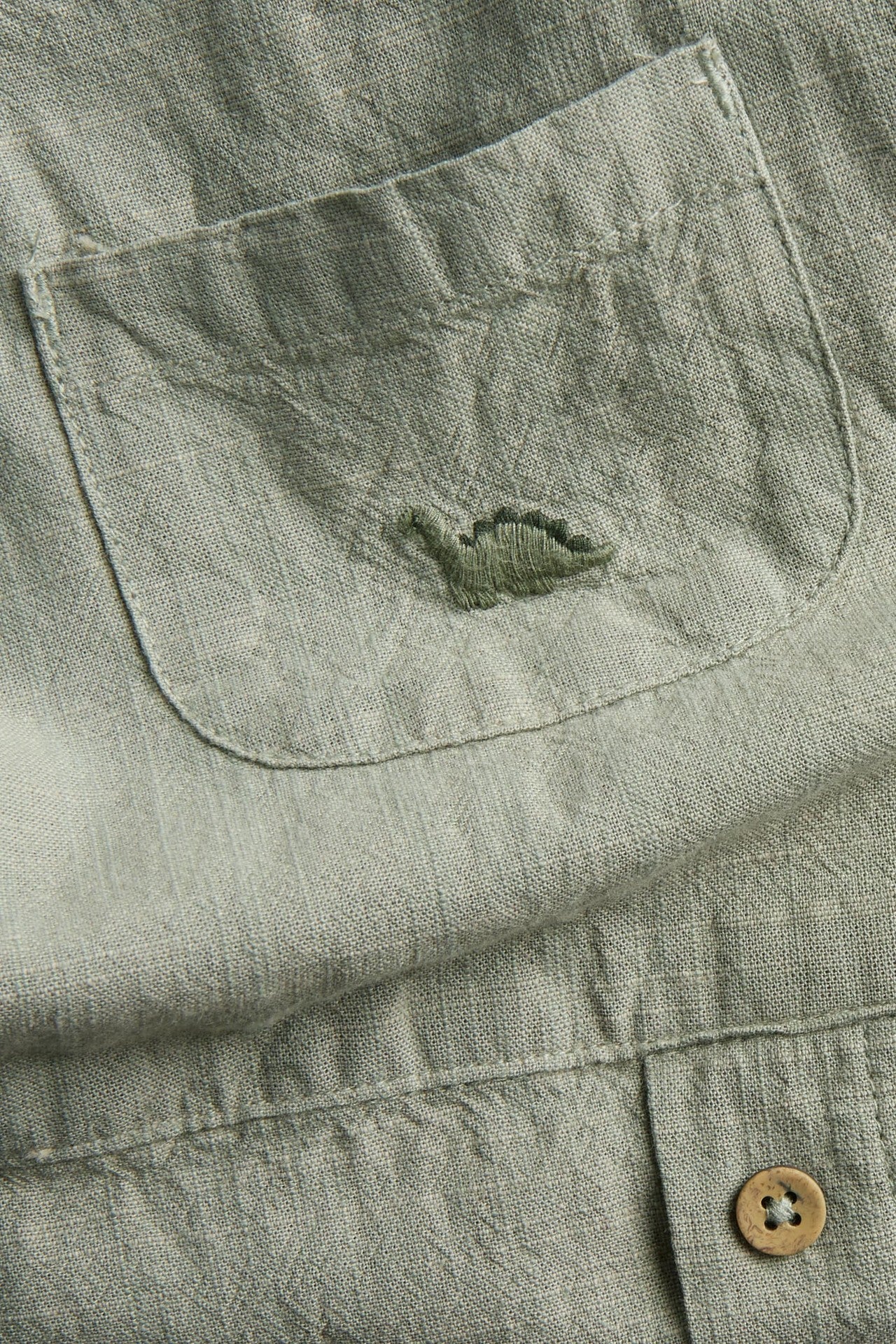 Baby green dinosaur dungarees - Image 2